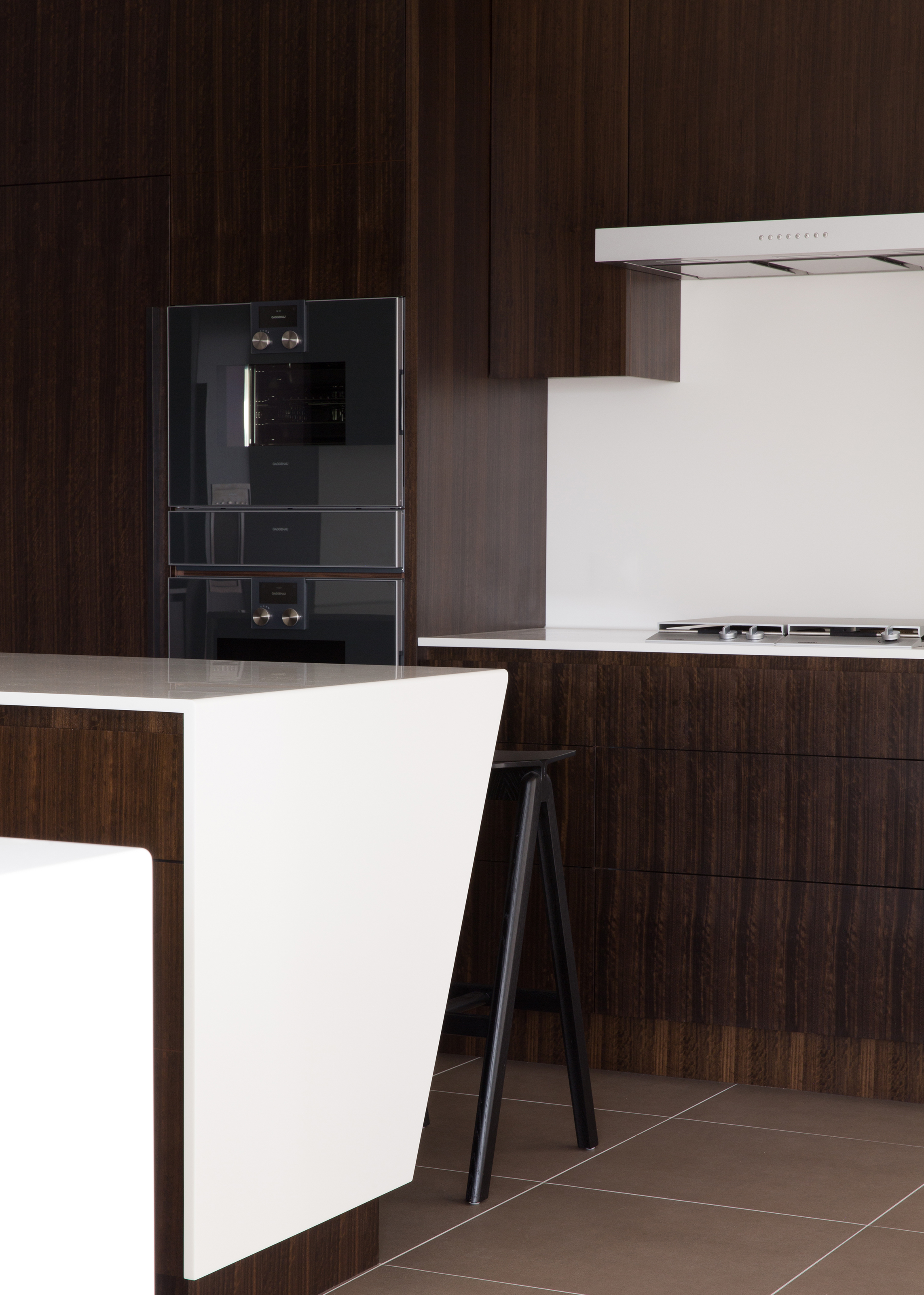 Angled Breakfast Bar With White Corian Worktop And Gaggenau